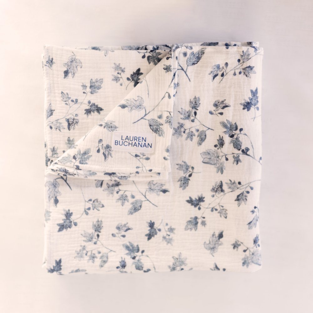 Fig muslin swaddle folded flat with the woven label