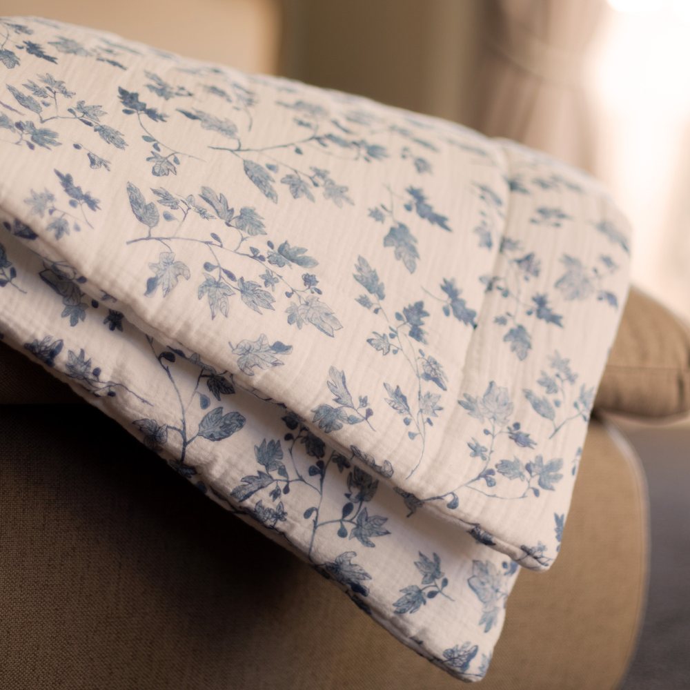Fig muslin playmat folded over a linen chair