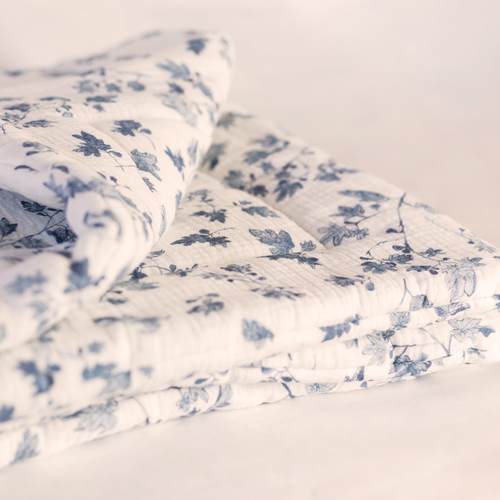 Fig muslin playmat folded, showing the quilted layers