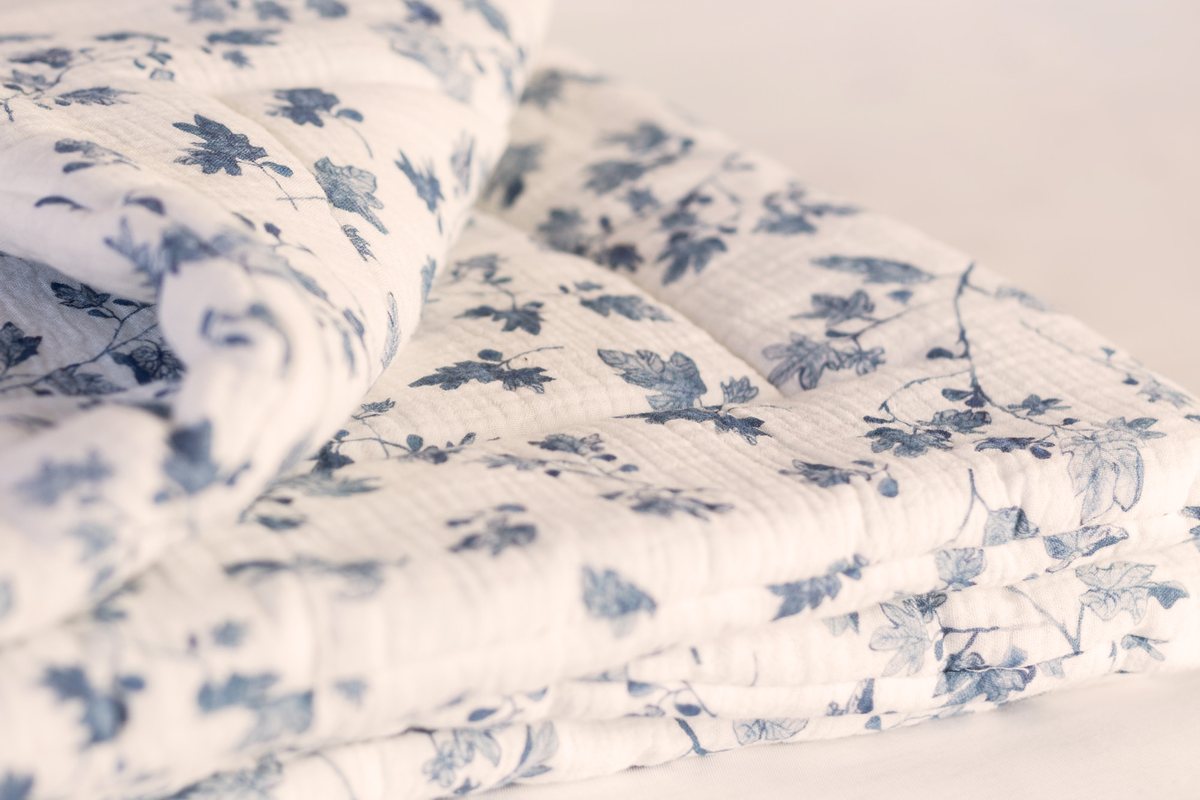 Fig muslin playmat folded, showing the quilted layers